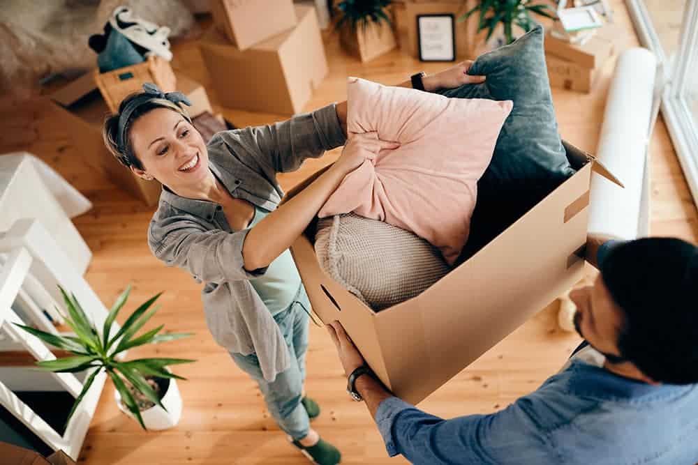 High angle view of happy couple unpacking their belongings at their apartment.