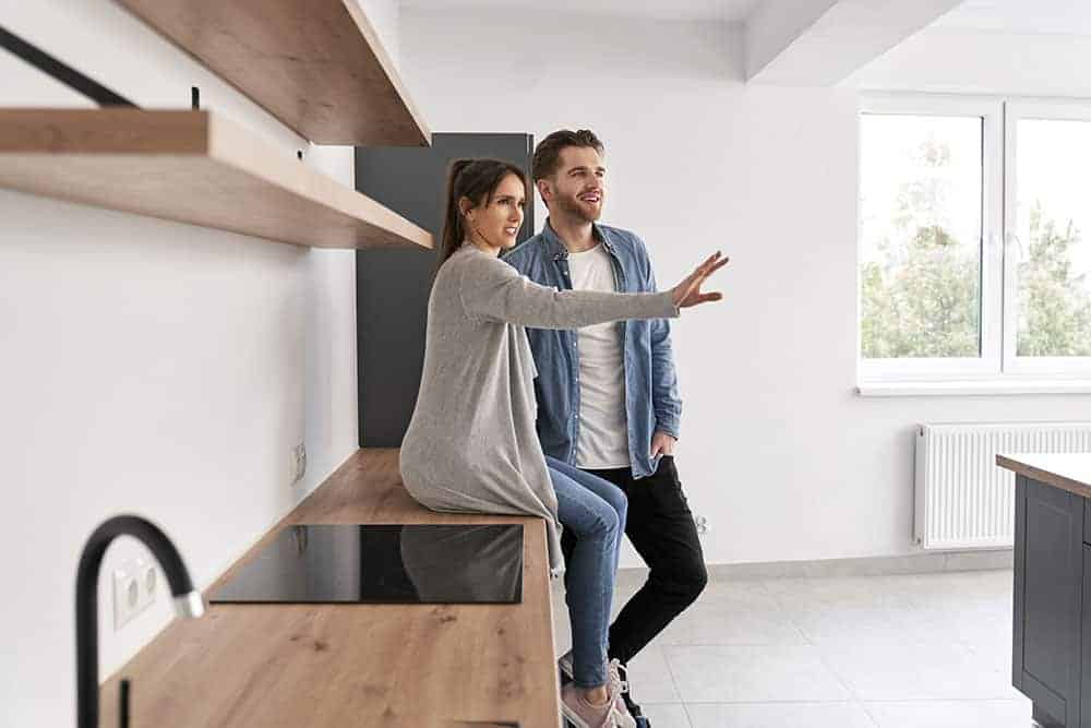 Very excited caucasian couple planning space in their new flat